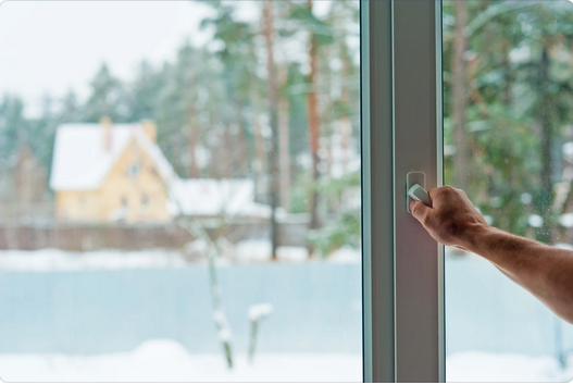 man opening slider to snowy outdoor backyard