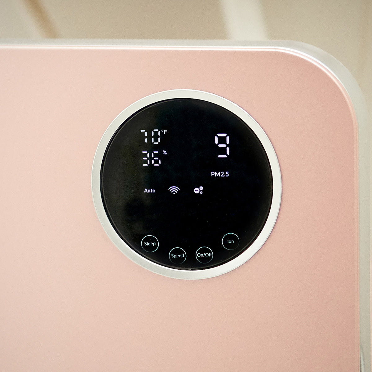 Close-up of the round touch display on the Klarta Forste air purifier in Rose (pink)