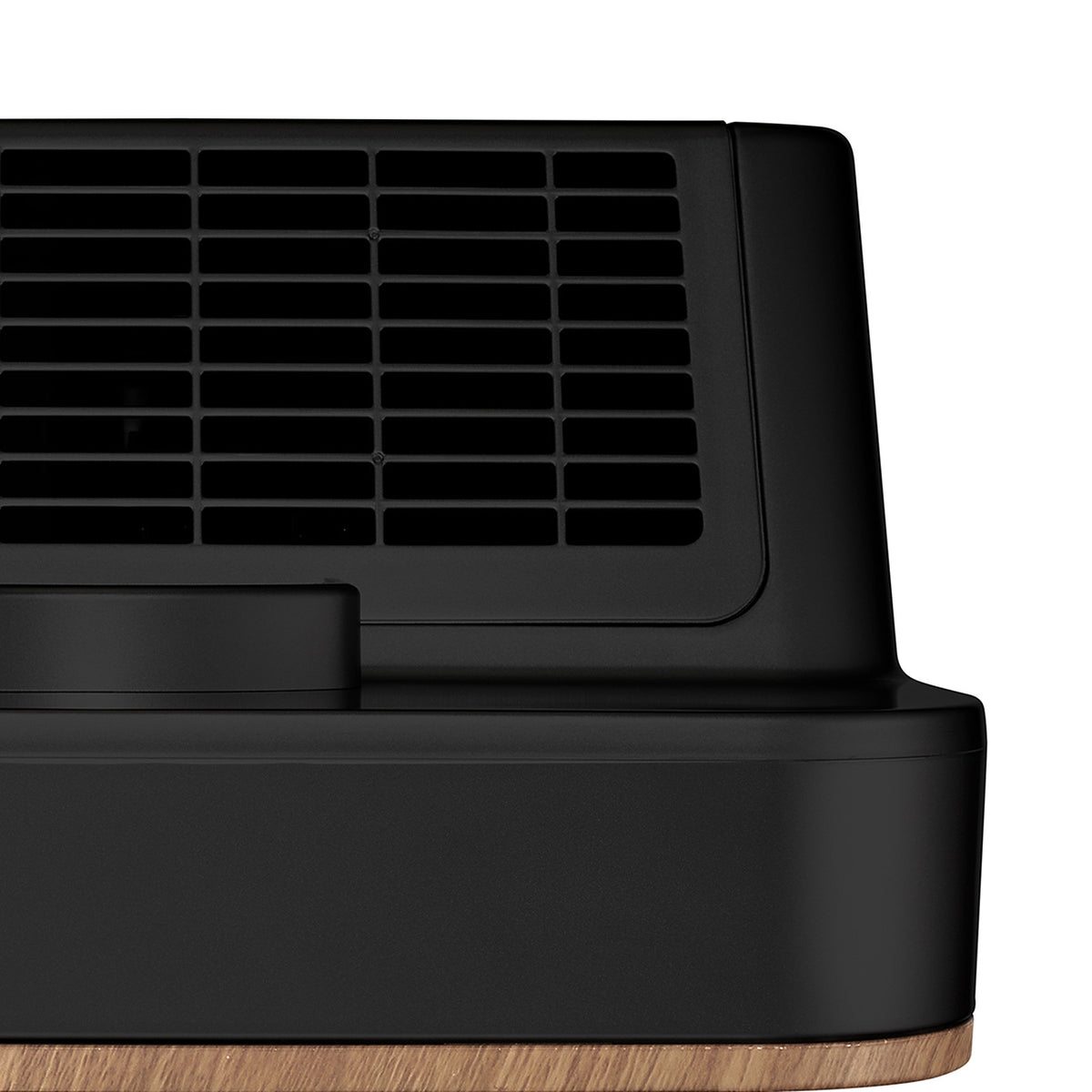 Top air outlet grille of the Klarta Forste air purifier in Wood Black, with the wood-grain panel edge below