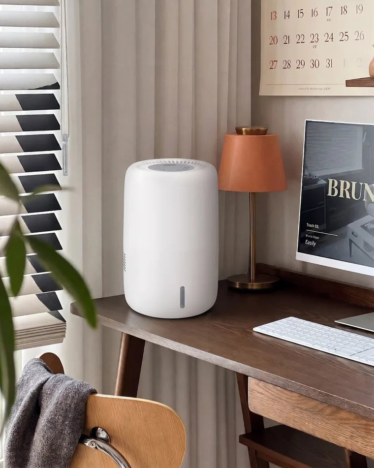 Klarta Humea evaporative humidifier in White on a wooden desk in a home office