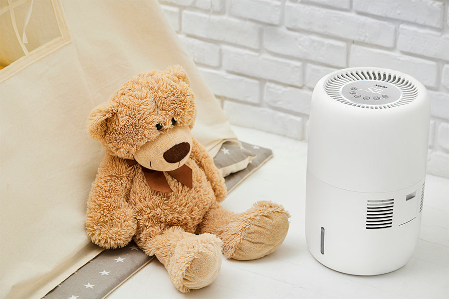 Klarta Humea humidifier in White next to a teddy bear in a child's room